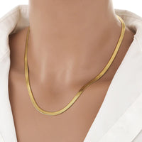 Anti-tarnish 18K gold plated flat herringbone snake chain 
necklace worn on neck — minimal gold stackable chain 
necklace for women