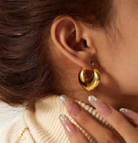 Aferando chunky puffy gold hoop earring worn on the ear