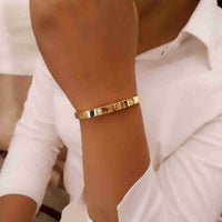 Close-up of screw motif detail on 18K gold plated bangle bracelet