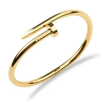 Close-up of gold nail bangle showing the sleek nail head detail and polished finish
Nail bangle worn on wrist, styled solo with a neutral outfit — minimal gold bangle for women
Nail bangle stacked with other gold bangles — stackable anti-tarnish bracelet for women
Nail bangle opening mechanism — anti-tarnish stainless steel bangle for women
Gold nail bangle bracelet in gift box — anti-tarnish jewellery gift for women