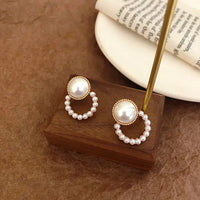 Aferando Gold Plated Korean Style Big Pearl Huggie Small Pearl Circle Hoop Stud Earrings, a unique and elegant piece of jewelry for women.