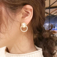 Aferando Gold Plated Korean Style Big Pearl Huggie Small Pearl Circle Hoop Stud Earrings, a unique and elegant piece of jewelry for women.