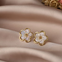 Aferando's Korean Style Gold Plated Flower Shape Pearl Stud Earrings for Women, featuring a unique flower shape design with a delicate pearl in the center, crafted in high-quality gold plating for a stylish and long-lasting accessory.