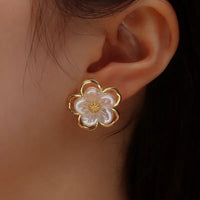 Aferando's Korean Style Gold Plated Flower Shape Pearl Stud Earrings for Women, featuring a unique flower shape design with a delicate pearl in the center, crafted in high-quality gold plating for a stylish and long-lasting accessory.