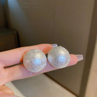 Aferando's White Oversized Uneven Texture Pearl Statement Stud Earrings for Women, beautifully crafted in gold plated material with a big size white pearl for a luxurious look.